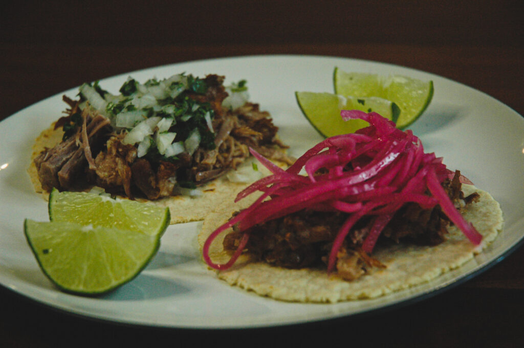 carnitas tacos with mexican relish and pickled onions