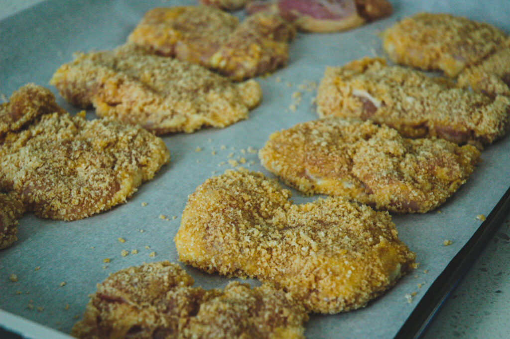 pork rind chicken on a baking sheet pre-baked