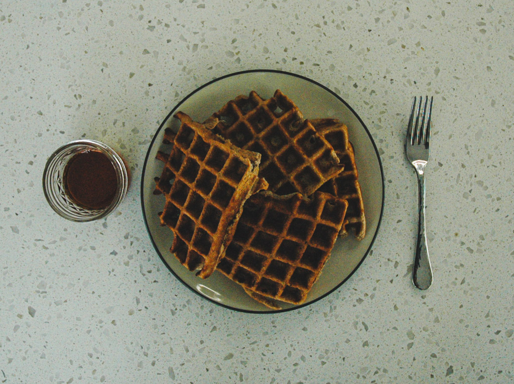 plated gluten free waffles ready to soak up maple syrup